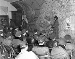 USAAF bomber crews at a briefing in England, United Kingdom, 1944-1945; note drawing of Me 163 Komet jet fighter on the map