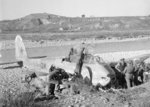 RAF Regiment troops inspecting a downed Me 410A-3 aircraft near the Sangro River, Italy, shortly after it was shot down on 26 Nov 1943