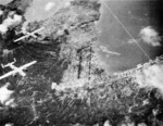 B-25 Mitchell bombers of US Army ComAirSols Bomber Command attacking Rabaul, New Britain, circa late 1943; note Lakunai airfield in top center of photo