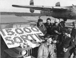 B-25 Mitchell crew of 310th Bomb Group, US 12th Air Force using doughnuts to celebrate its 15,000th sortie, Corsica, France, Aug 1944