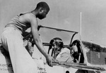 US Army African-American aviators crew chief Staff Sergeant Alfred D. Norris and pilot Captain William T. Mattison prepared for a mission with a P-51 Mustang fighter, Italy, circa Sep 1944