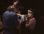 Two female employees of North American Aviation working on a section of a wing of a P-51 Mustang fighter, California, Oct 1942