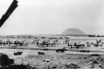 P-61 Black Widow and P-51 Mustang fighters at Iwo Jima, Japan, 1945; note one TBM Avenger (wings folded) and one C-46 Commando aircraft in background