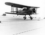 Commander of VGS-1 squadron Lieutenant Commander Lex L. Black making the 2,000th landing on escort carrier Long Island in a SOC-3A Seagull aircraft, 20 Apr 1942