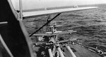 View on battleship California, looking aft from inside a SOC-3 floatplane atop the turret # 3 catapult, showing two more SOC-3 aircraft, 1938