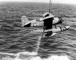 SOC-1 Seagull aircraft of US Navy Cruiser Scouting Squadron Seven being recovered by its parent cruiser, Jul 1943