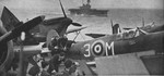 Spitfire Mk. VC aircraft aboard USS Wasp, en route to Malta in the Mediterranean Sea, mid-1942; note HMS Eagle in background