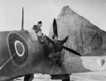 USAAF Colonel Harold B. Willis, Major Marvin L. McNickle, and Captain A. E. Vinson observing an aircraft in flight from a Spitfire aircraft, Gibraltar, 1942