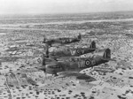 Three British Spitfire Vb fighters in flight over Djerba Island, Gulf of Gabes, Tunisia, early 1943