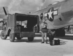 US Army personnel unloading photographic equipment from a B-29 Superfortress reconnaissance aircraft, Saipan, Mariana Islands, 1945