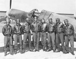 US Army Air Force Tuskegee airmen in front of a P-40 Warhawk fighter, Southern Italy or North Africa, circa May 1942 to Aug 1943
