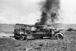 A British truck and trailer burning after attacked by German Luftwaffe aircraft, Crete, Greece, 25 Jun 1941