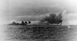 Bismarck firing on Hood and Prince of Wales, Battle of Denmark Strait, 24 May 1941, photo 4 of 8; photographed from Prinz Eugen, note shells from Prince of Wales splashing short and Bismarck listing b