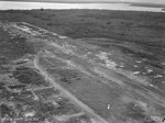 View of airstrip on Tarakan, Borneo, showing extensive damage sustained during battle and some reconstruction efforts commited by 1st and 8th Airfield construction Squadrons of RAAF, 21 May 1945