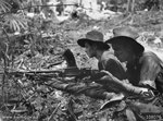Private D. E. Hailey and T. M. Conway of the Australian 2/23 Infantry Battalion in their Bren gun pit on the forward slope of B Company position, Tarakan, Borneo, May 1945