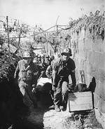 US Army medics removing a casualty from the battlefield to an aid station in an air shelter, near Brest, France, 28 Aug 1944