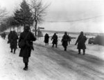 Troops of US 101st Airborne Division moving out of Bastogne, Belgium, 31 Dec 1944