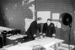 British Royal Navy Commander Cross reviewing a convoy movement map with Captain Lake, Derby House, Liverpool, England, United Kingdom, 26 or 27 Sep 1944