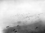 C-47 Skytrain transport aircraft releasing hundreds of paratroopers and their supplies over the Rees-Wesel region in North Rhine-Westphalia, Germany during Operation Varsity, 24 Mar 1945