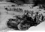 German Panzer III tank and troops in winter camouflage in the Demyansk Pocket, Russia, spring 1943