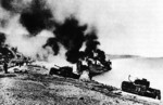 British Churchill tanks and landing craft burning on the Dieppe beach, France, 19 Aug 1942