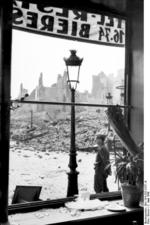 View of ruins of Calais, France from a broken shop window, 5 Jun 1940