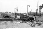 Damaged military universal carrier and civilian vehicles near the docks of Calais, France, May 1940