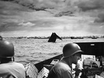 US Coast Guard personnel transporting supplies to Tarawa, Gilbert Islands, circa 20-23 Nov 1943; note the wreck of an American LCVP in center of photo