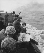 US Marines with a pin-up girl picture in a landing craft, off Tarawa, Nov 1943