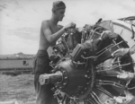 US Marine aircraft mechanic at work, Henderson Field, Guadalcanal, Solomon Islands, Nov 1942