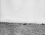 US Army Air Force B-17s overfly US Marine and US Navy F4F or FM-2 Wildcat aircraft at Henderson Field, Guadalcanal, Solomon Islands, 1942