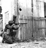 Canadian soldier with Lee-Enfield rifle in Ortona, Italy, Dec 1943