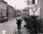 US Army Sergeant Joseph H. Kadlec delivering Christmas packages sent from home, Zweifall near Aachen, Germany, 14 Nov 1944