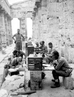 A company of African American soldiers of the US Army working at a makeshift office located at an ancient Neptune temple in Italy, 22 Sep 1943