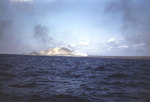 Battleship Tennessee bombarding the base of Mount Suribachi before the initial landings, causing a huge explosion, Iwo Jima, 19 Feb 1945
