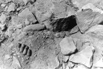 Hand of a buried Japanese soldier showing through the remains of a collapsed defensive position, Iwo Jima, Mar 1945