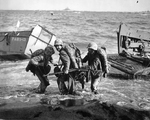 US Marine hauling an ammunition cart on Iwo Jima invasion beach, Japan, 19 Feb 1945