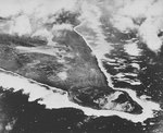 Aerial photograph of Iwo Jima during a raid on its southern Airfield Number One, early 1945, photo 1 of 2