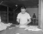 Chief Postal Orderly Masaki Hironoka at work at the post office at Jerome War Relocation Center, Arkansas, United States, 20 Nov 1942