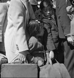 Japanese-American children awaiting for a bus that would take them to an Assembly Center, Byron, California, United States, 2 May 1942