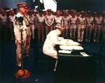 MacArthur signing Japanese surrender aboard USS Missouri, 2 Sep 1945, photo 2 of 4