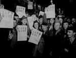 Soldiers at the Rainbow Corner Red Cross Club in Paris, France displayed their copies of Paris Post special edition announcing Japanese surrender, 10 Aug 1945