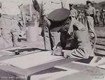 Australian Army Brigadier L. G. H. Dyke, CBE DSO, signing the instrument of surrender for all Japanese forces in the Lesser Sundas, Koepang, Timor, 3 Oct 1945; photo 3 of 3