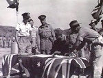 Lt. Gen. K. Yamada of Japanese 48th Division signing the surrender of the Lesser Sundas, Timor, 3 Oct 1945; Australian Pilot Officer E Weatherstone & Brigadier LGH Dyke look on; photo 2 of 3