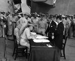 Lieutenant General Sutherland correcting Japanese surrender document, 2 Sep 1945, photo 1 of 2
