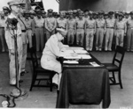 MacArthur signing Japanese surrender aboard USS Missouri, 2 Sep 1945, photo 3 of 4