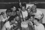 US Marine Corporal John Dulin using a captured Japanese sword to cut a cake baked for victory celebration, Okinawa, Japan, Aug 1945