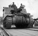 Sexton 25-pounder self-propelled howitzer of UK 11th Armored Division cross the Seine River, France on a Bailey bridge, 30 Aug 1944