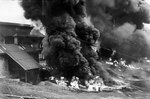 Stocks of rubber, held by a factory on a rubber plantation in Malaya, were burned during the British retreat toward Singapore, Dec 1941
