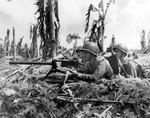 US Marines Gunnery Sergeant J. Paget and Privates L. C. Whether and V. A. Sot with their Browning M1919 machine gun, about 100 yards in-land from the Guam invasion beach, Mariana Islands, 28 Jul